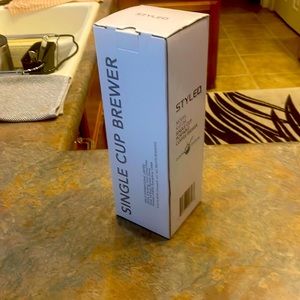 A single cup coffee brewer. (Brews similar to a Keurig)